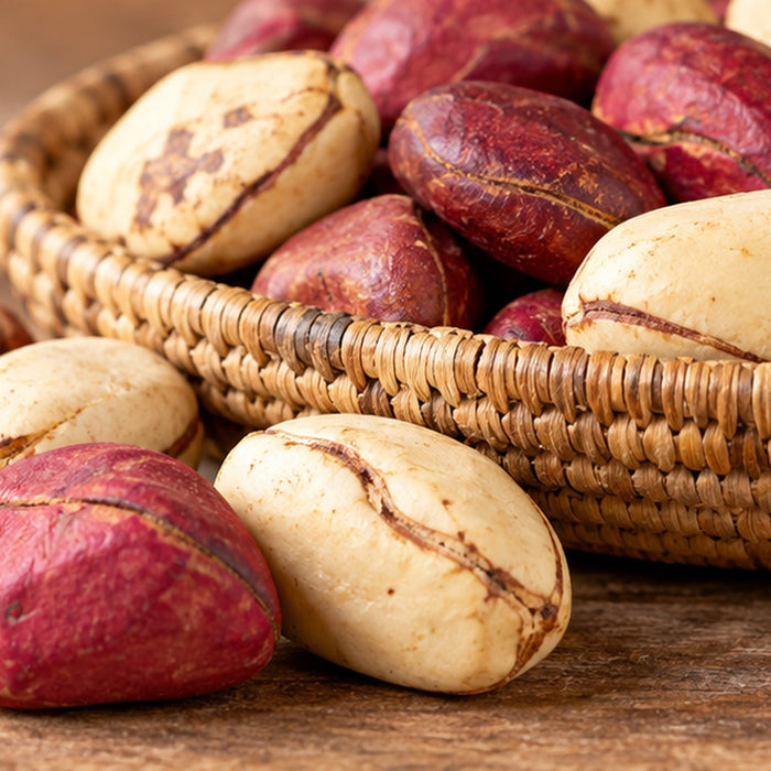 Illustrative lifestyle image of red and white kola nuts arranged in a woven basket