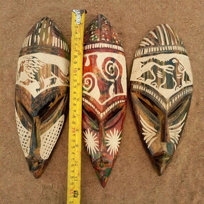 Set of three handmade Ghanaian wooden African wall masks featuring traditional carving and decorative details. Authentic African wall art handcrafted in Ghana by skilled artisans, ideal for living room décor, office decoration, and cultural art collections. Unite Root Africa.